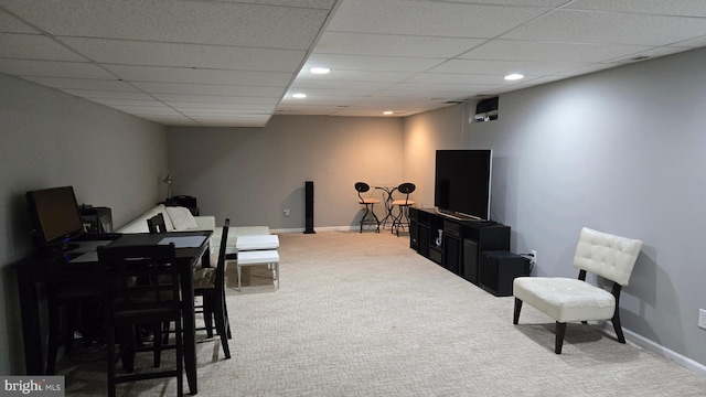 carpeted living room with a paneled ceiling