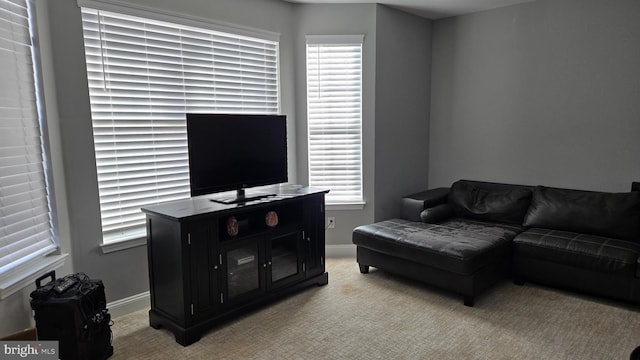 living room with plenty of natural light and light colored carpet