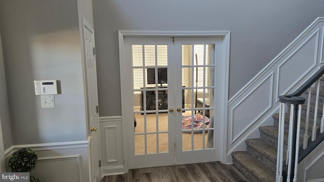 entryway with dark wood-type flooring and french doors