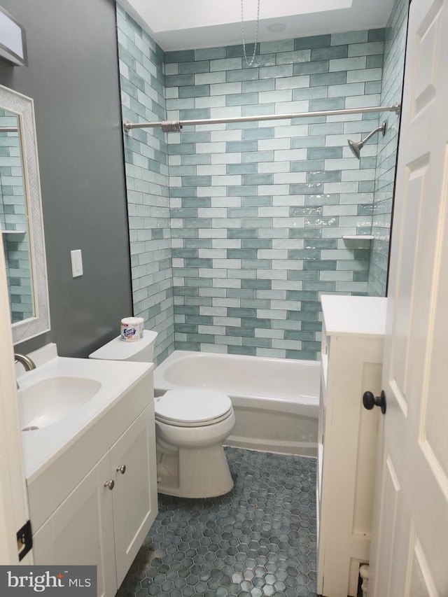 full bathroom with tile patterned flooring, vanity, toilet, and tiled shower / bath combo