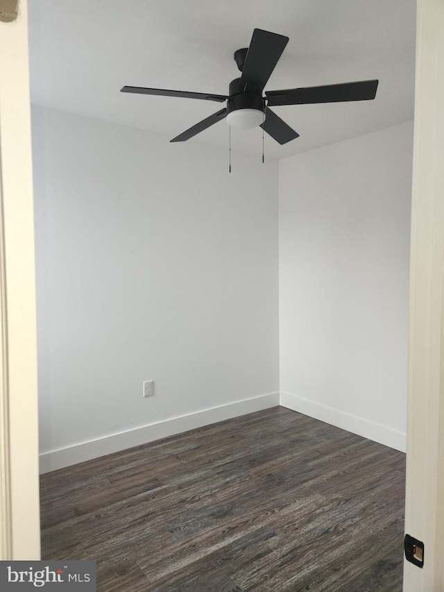 spare room with ceiling fan and dark hardwood / wood-style flooring