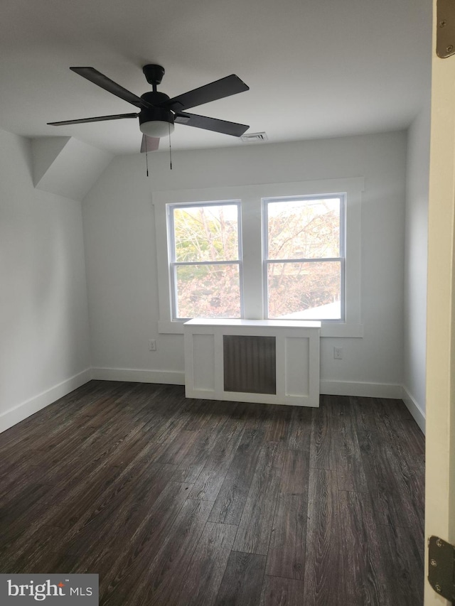 bonus room with ceiling fan, dark wood-type flooring, and vaulted ceiling