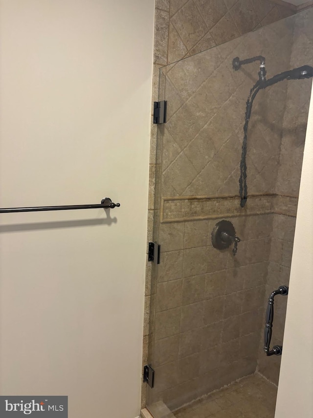 bathroom with a shower with door