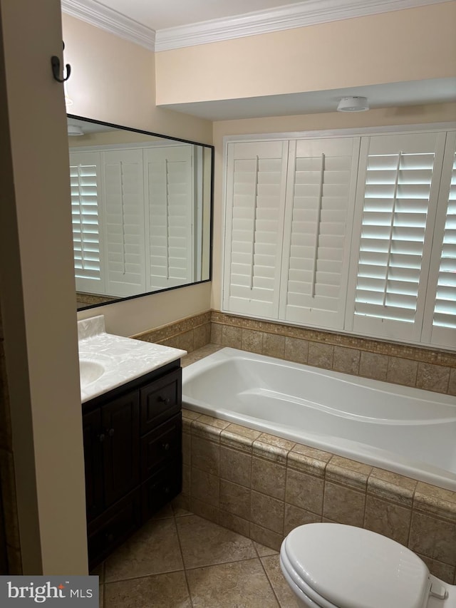 bathroom featuring tile patterned floors, crown molding, vanity, and toilet