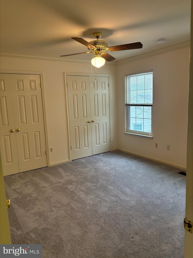 unfurnished bedroom with light colored carpet, ceiling fan, and ornamental molding