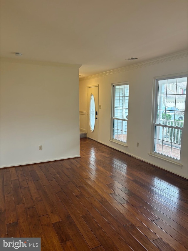 entryway with ornamental molding and dark wood-type flooring