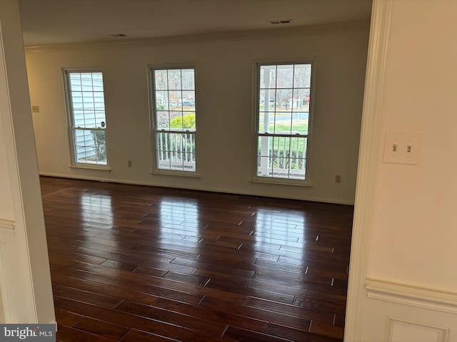 spare room with dark hardwood / wood-style flooring and ornamental molding