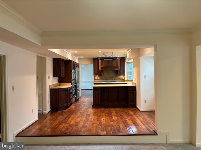 kitchen with dark brown cabinetry, dark hardwood / wood-style floors, and ornamental molding