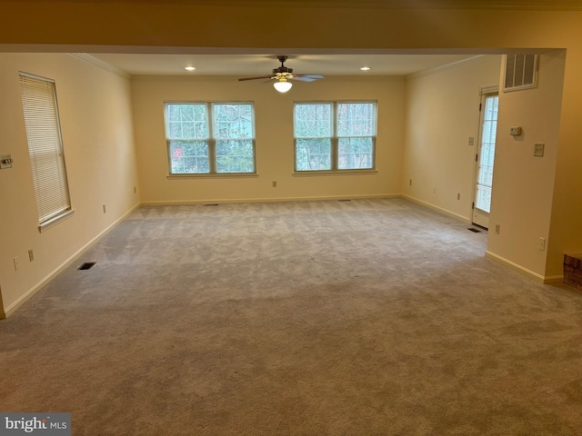 unfurnished living room featuring ceiling fan, carpet floors, and ornamental molding