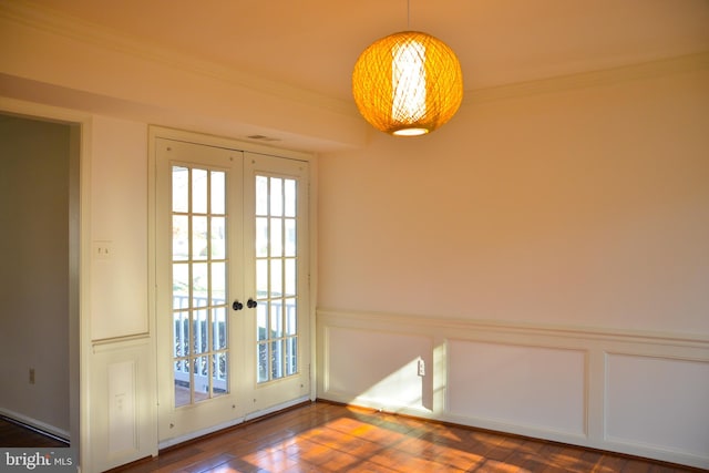 doorway to outside with french doors, dark hardwood / wood-style floors, and ornamental molding