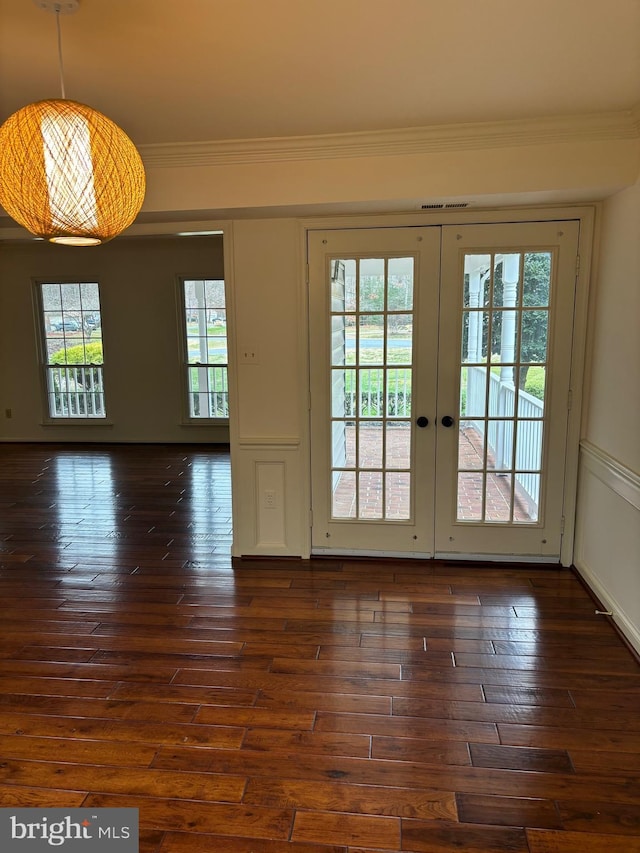 doorway featuring crown molding, french doors, and dark wood-type flooring