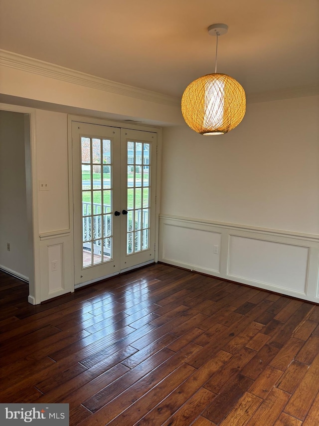 unfurnished dining area with french doors, ornamental molding, and dark wood-type flooring