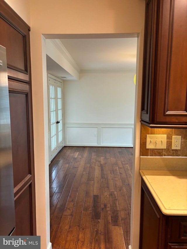 kitchen with dark hardwood / wood-style floors, crown molding, backsplash, and french doors