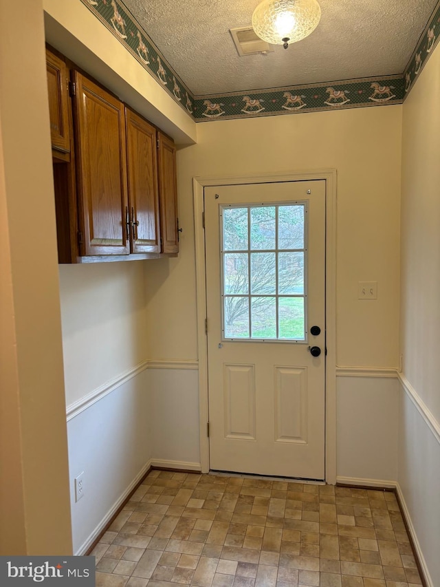 doorway featuring a textured ceiling