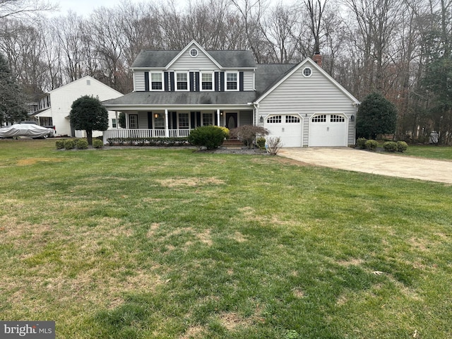 view of front of property featuring a front yard, a porch, and a garage