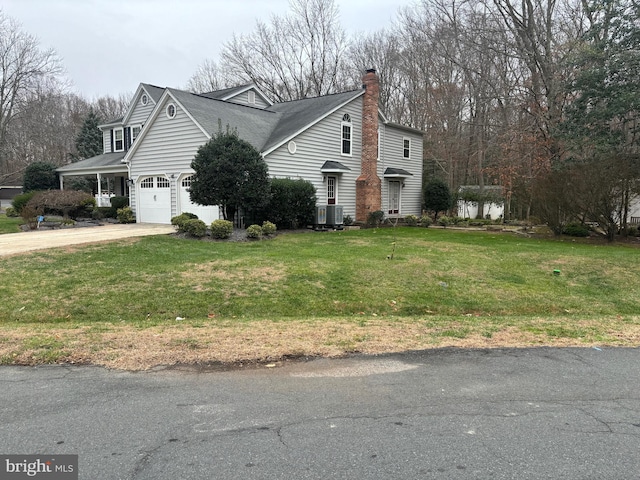 view of side of home featuring central AC, a garage, and a lawn