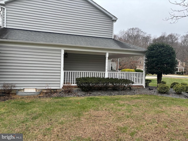 view of side of property featuring a yard and a porch