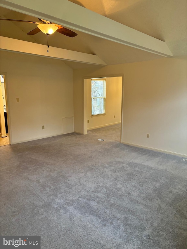 empty room featuring ceiling fan, carpet, and lofted ceiling with beams