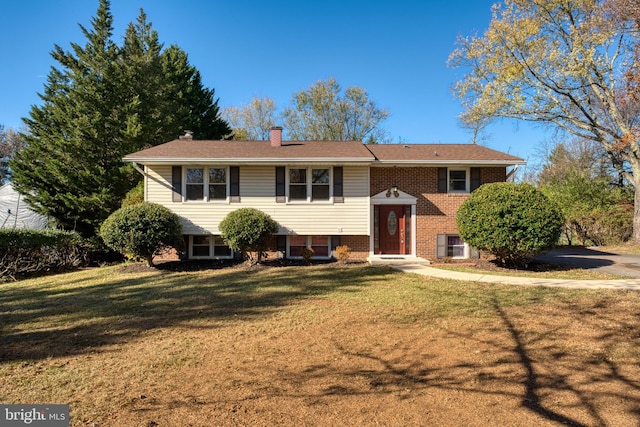 raised ranch featuring a front yard