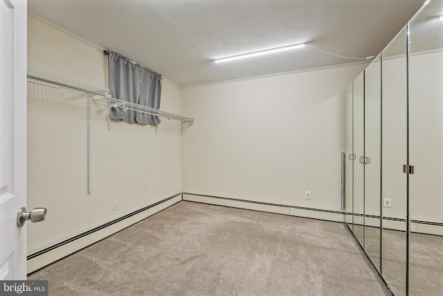 interior space featuring baseboard heating and light carpet