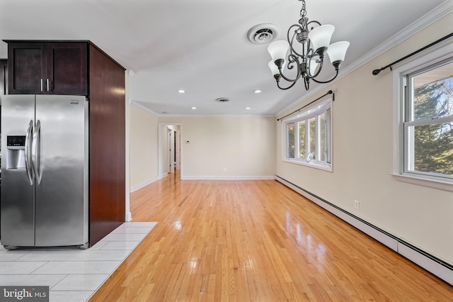 kitchen with baseboard heating, stainless steel refrigerator with ice dispenser, a wealth of natural light, and light hardwood / wood-style flooring