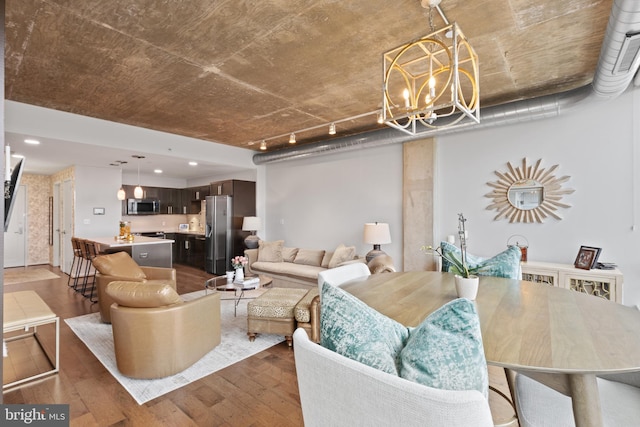 living room with hardwood / wood-style flooring and an inviting chandelier