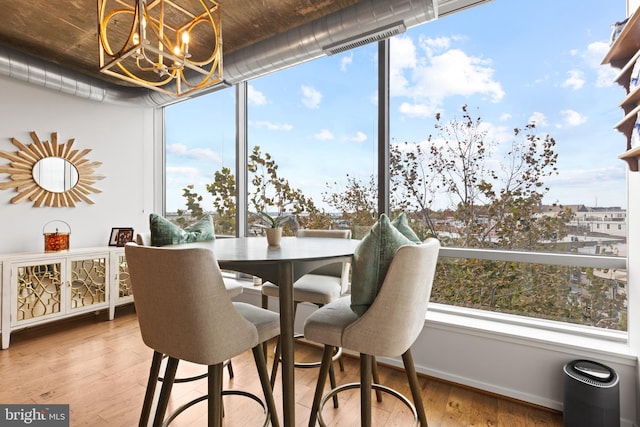 sunroom featuring a notable chandelier and a healthy amount of sunlight