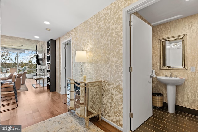 hallway featuring dark wood-type flooring and sink