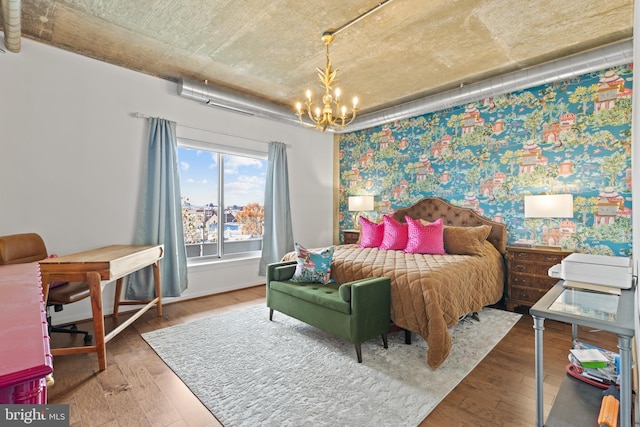 bedroom with a chandelier and wood-type flooring