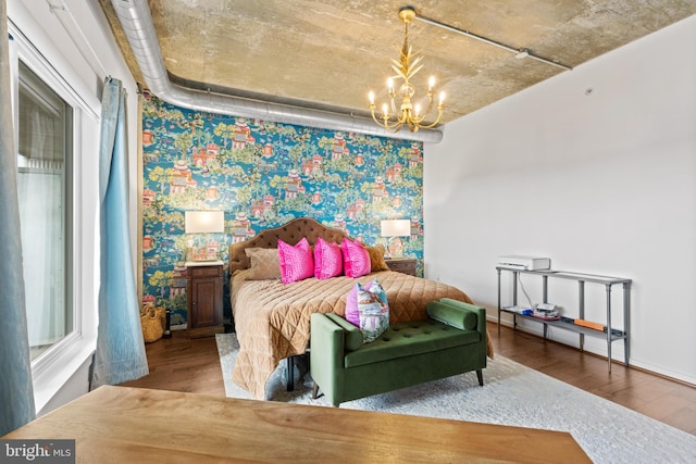 bedroom with hardwood / wood-style floors and a notable chandelier