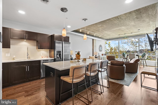 kitchen with decorative light fixtures, dark hardwood / wood-style flooring, sink, and appliances with stainless steel finishes