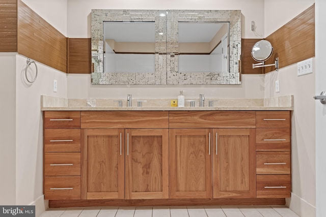 bathroom with tile patterned flooring and vanity