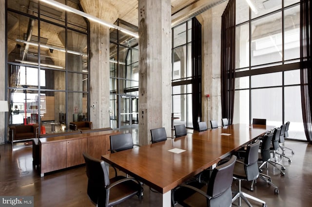 interior space with a towering ceiling, floor to ceiling windows, and a healthy amount of sunlight