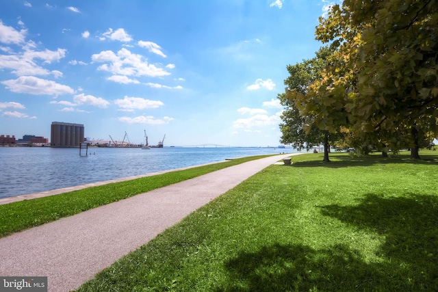 view of community with a lawn and a water view