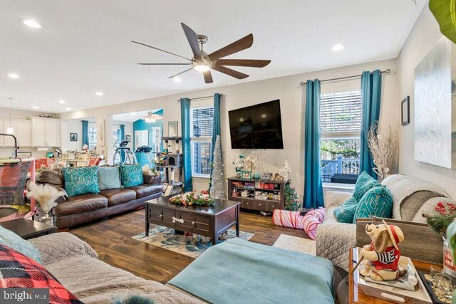 living room featuring dark hardwood / wood-style flooring and ceiling fan