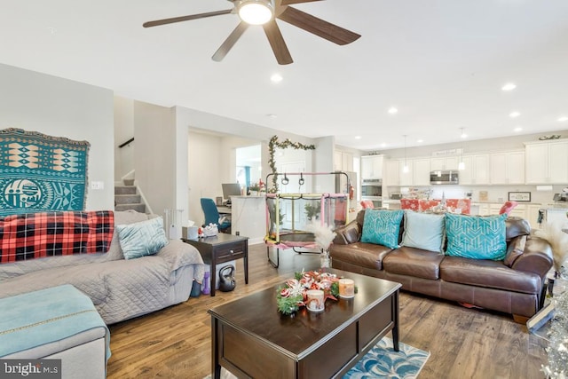 living room with ceiling fan and light hardwood / wood-style flooring