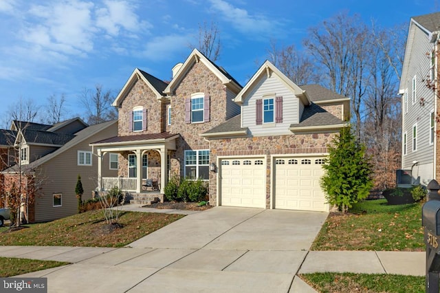 view of front of property with a garage, a front lawn, and covered porch