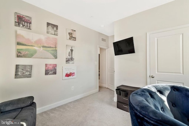 sitting room featuring light colored carpet