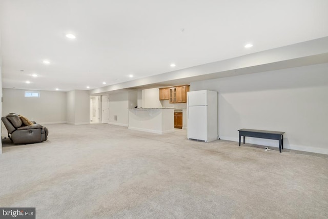 basement with light colored carpet and white fridge