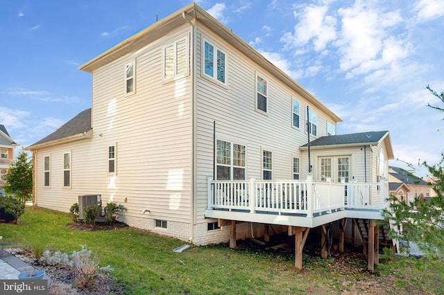 rear view of house with central AC, a yard, and a deck