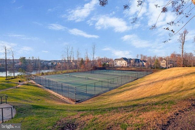 view of sport court featuring a lawn