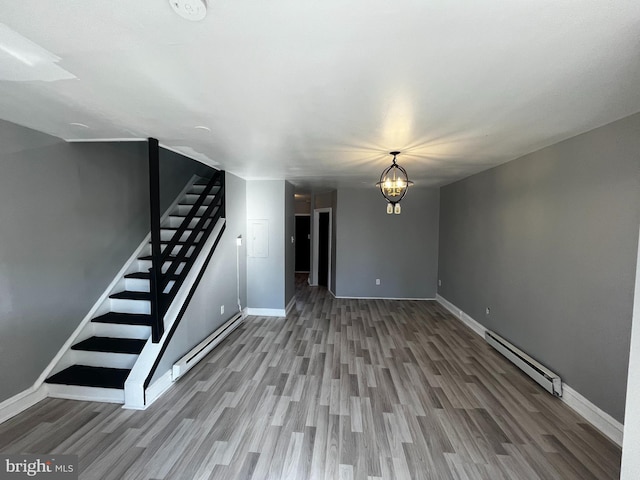 interior space featuring a chandelier, hardwood / wood-style floors, and a baseboard radiator