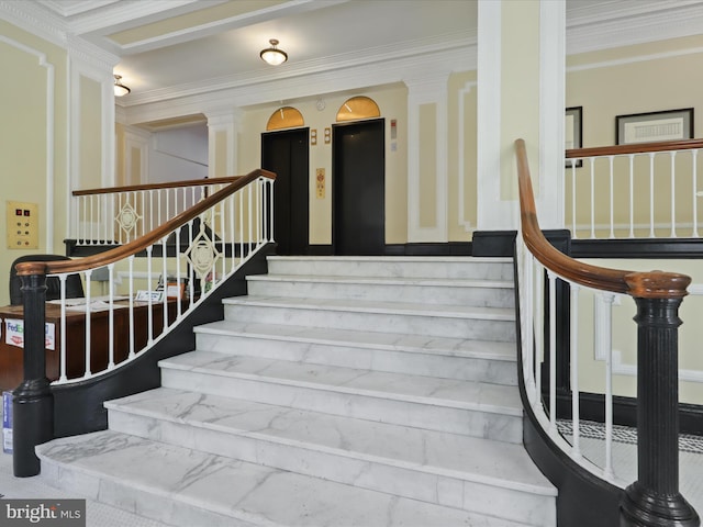 stairs featuring ornate columns and ornamental molding