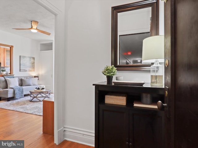 corridor with hardwood / wood-style floors