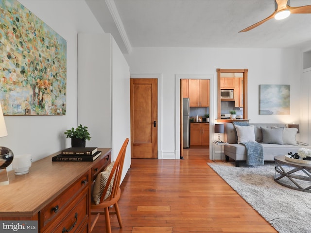 living room with ceiling fan and light hardwood / wood-style floors