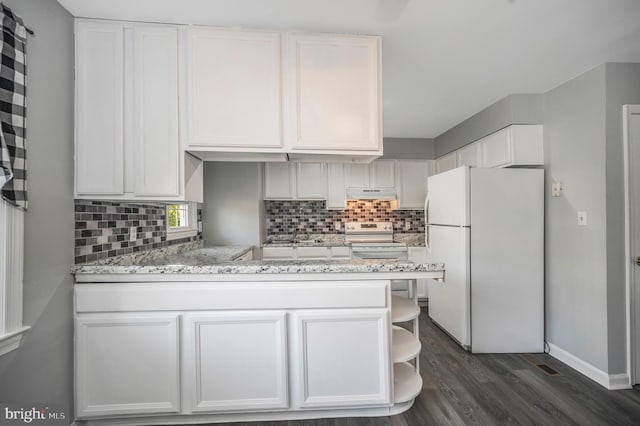 kitchen featuring light stone countertops, dark hardwood / wood-style floors, white fridge, electric stove, and white cabinets