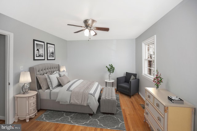 bedroom with light wood-type flooring and ceiling fan