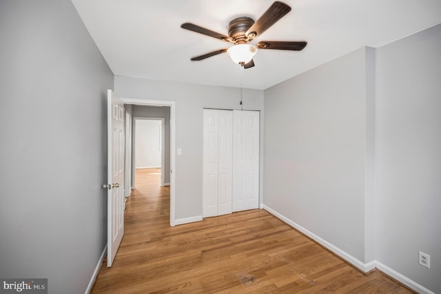 unfurnished bedroom featuring a closet, ceiling fan, and light hardwood / wood-style flooring