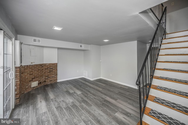 basement with dark hardwood / wood-style flooring