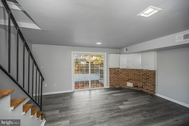 unfurnished living room with dark hardwood / wood-style floors